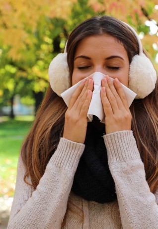 girl sneezing in garden